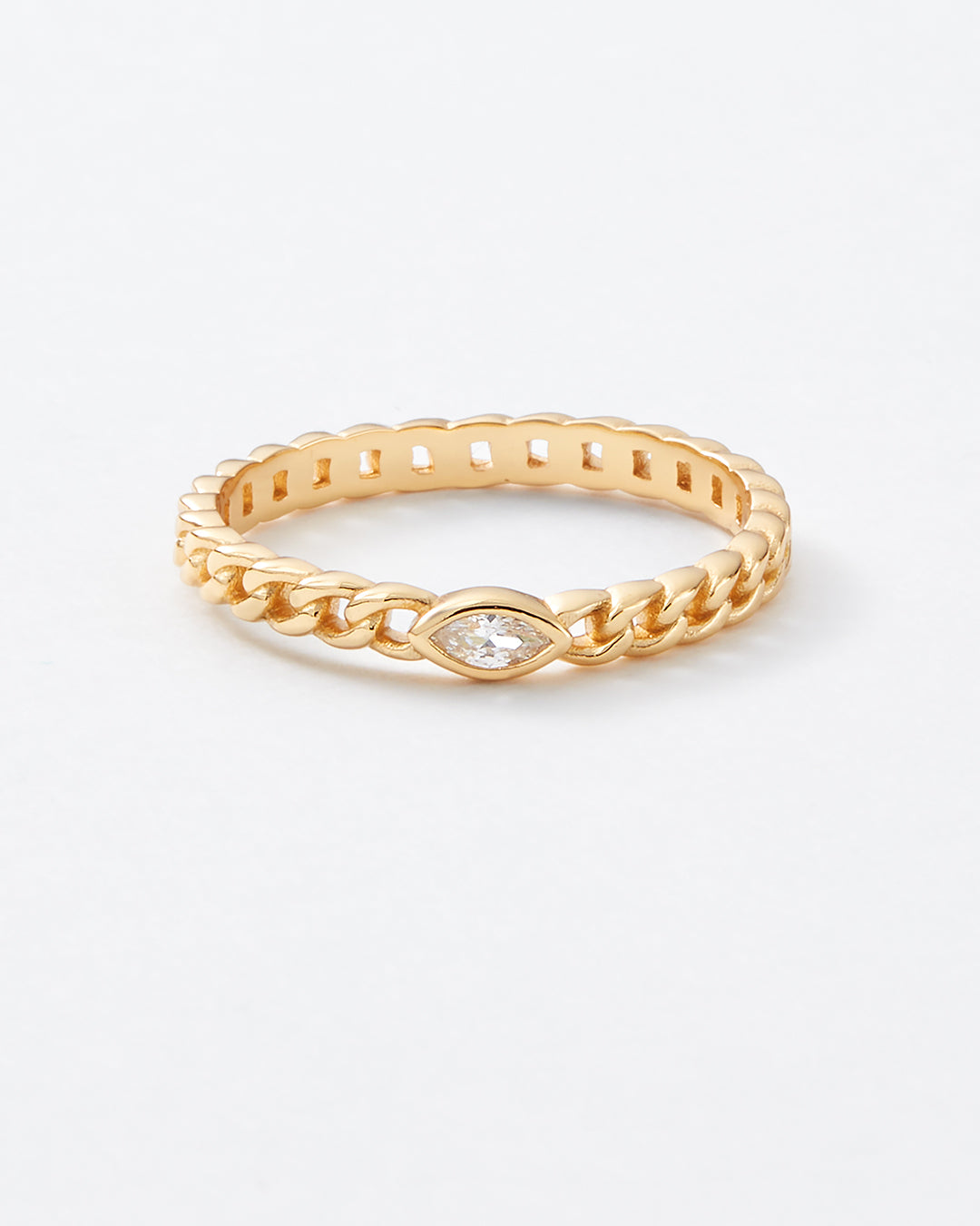 A gold chain-link band ring featuring a marquise-cut clear gemstone at the center, displayed on a clean white background.