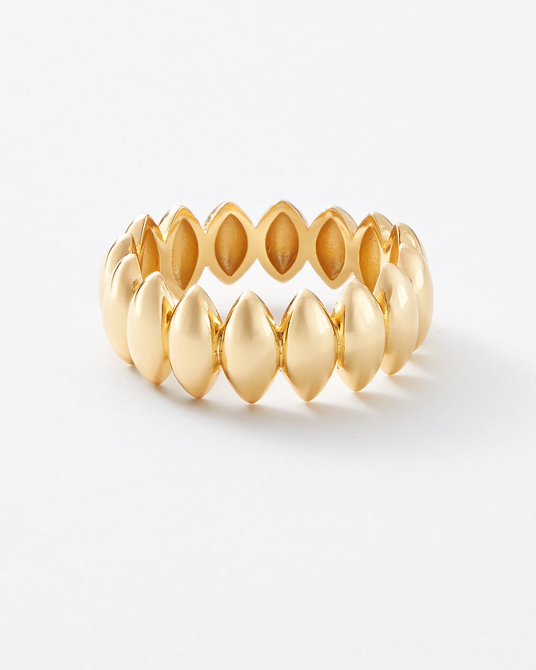 A gold stretch band ring with a series of teardrop-shaped links, photographed on a clean white background.