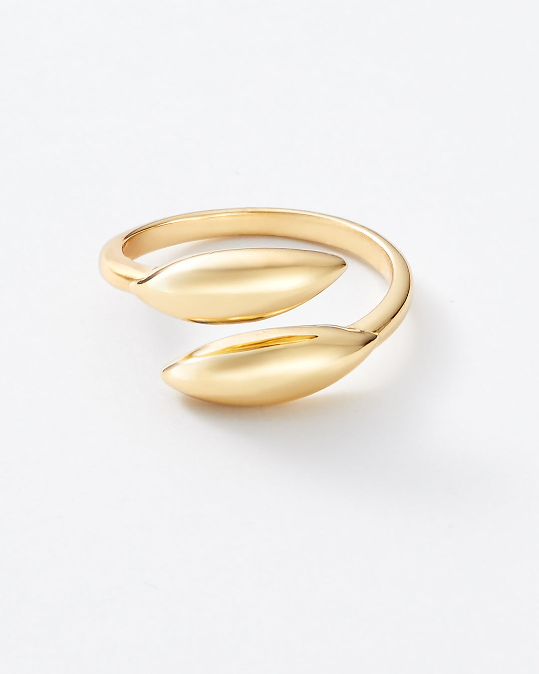 A gold wrap ring with a minimalist, organic leaf-like design, photographed on a clean white background.