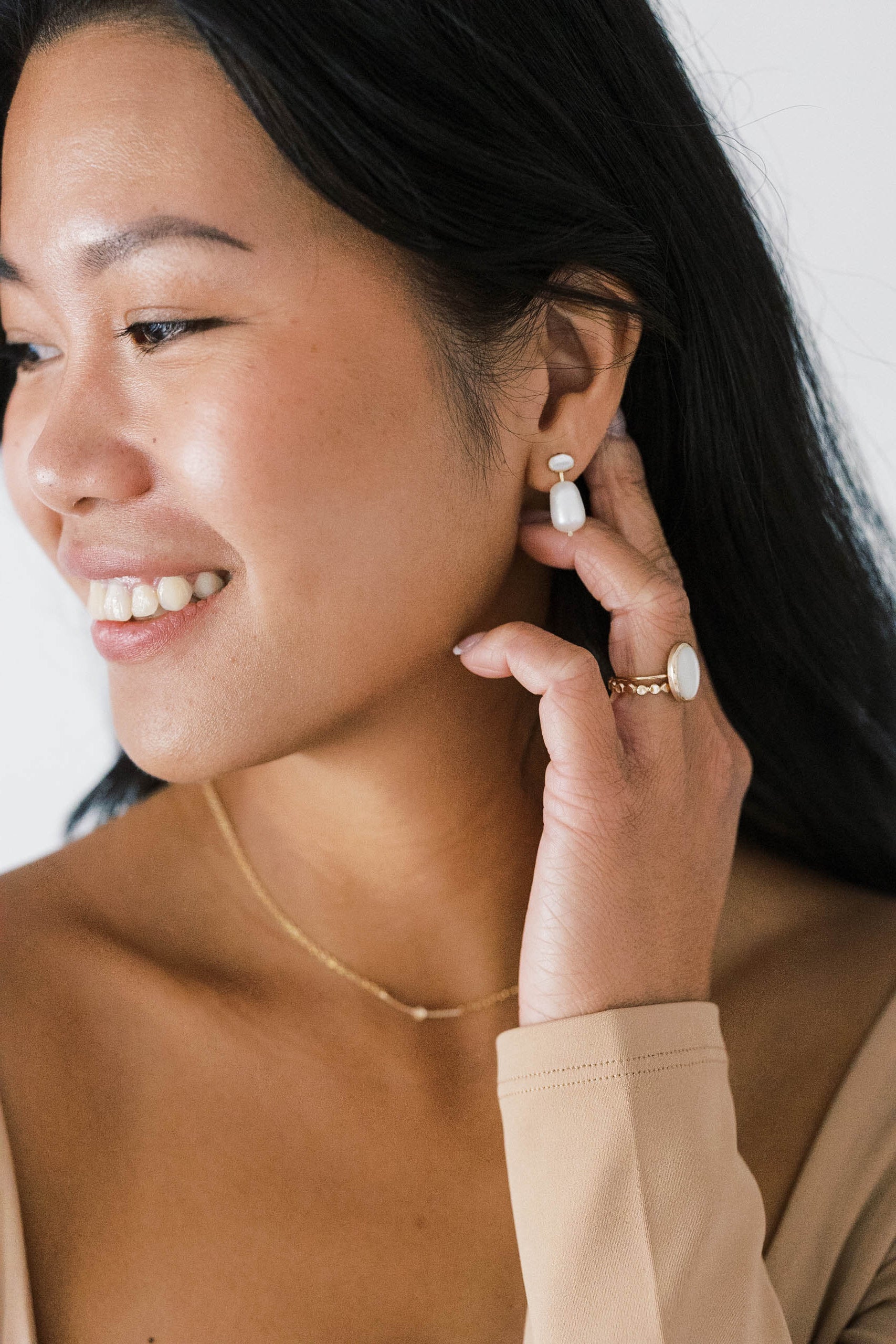 Large oval mother of pearl is set into a gold ring band. This ring is stackable. It is made with recycled gold fill.