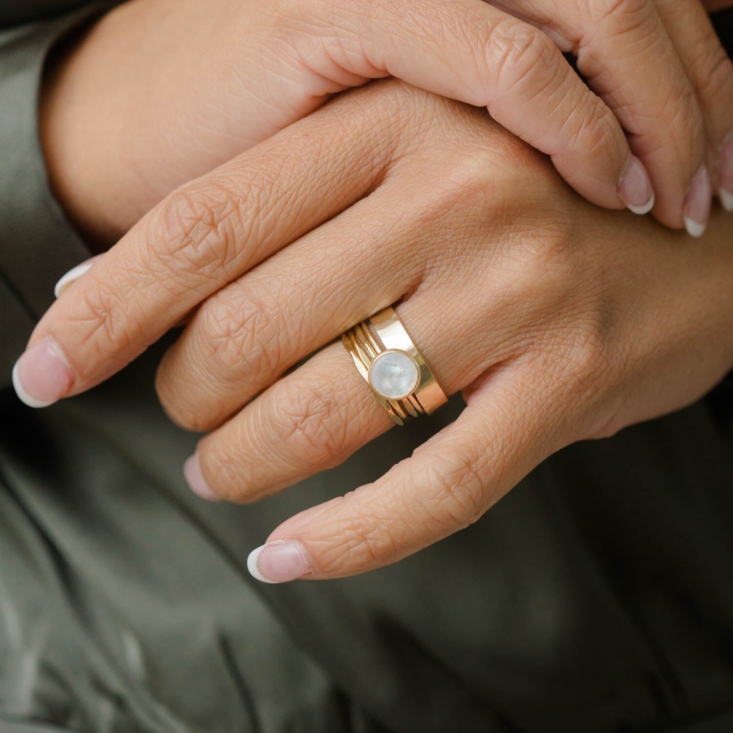 Gold layering ring stacks.