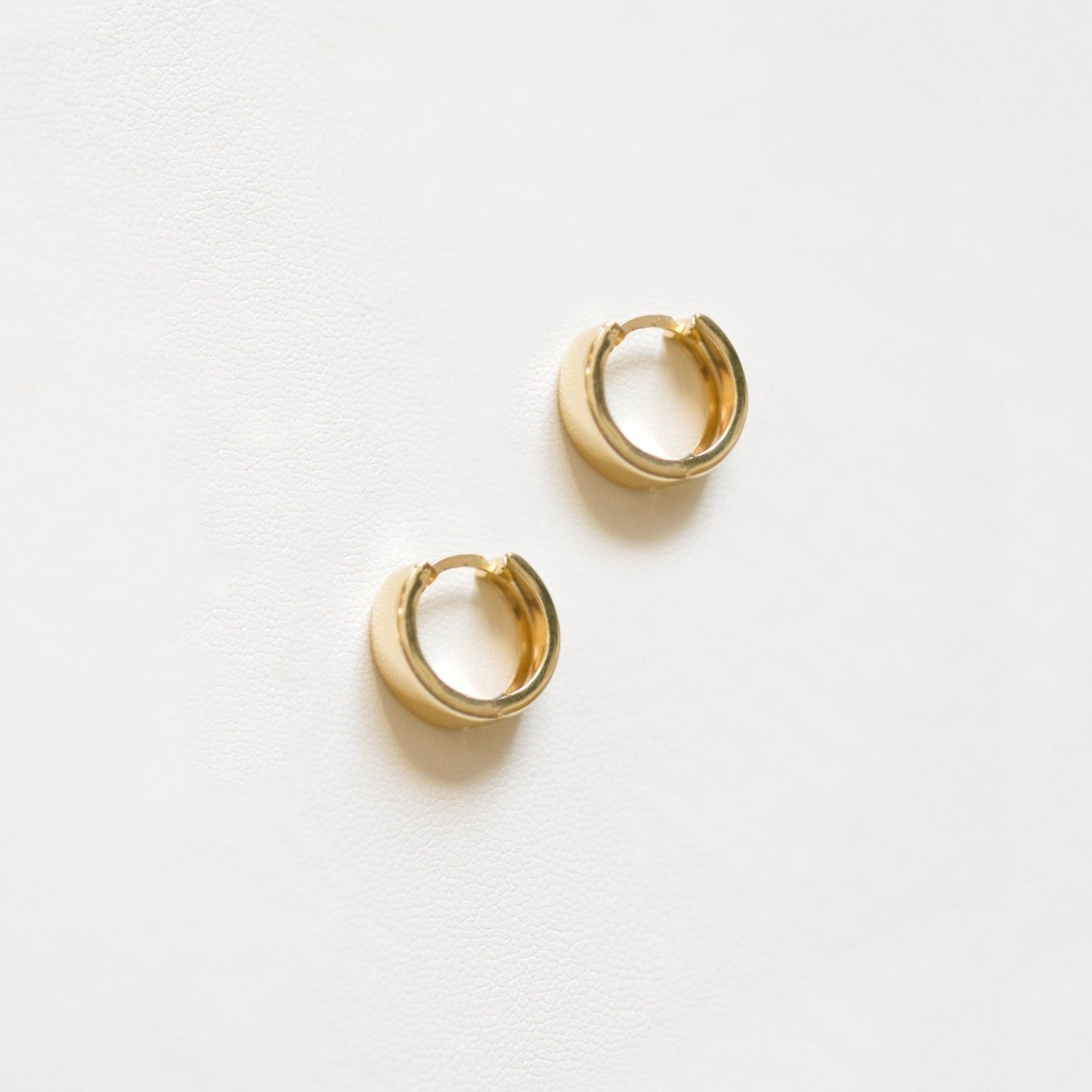 Gold huggie hoops are the ultimate classic earring. These are 14k yellow gold.