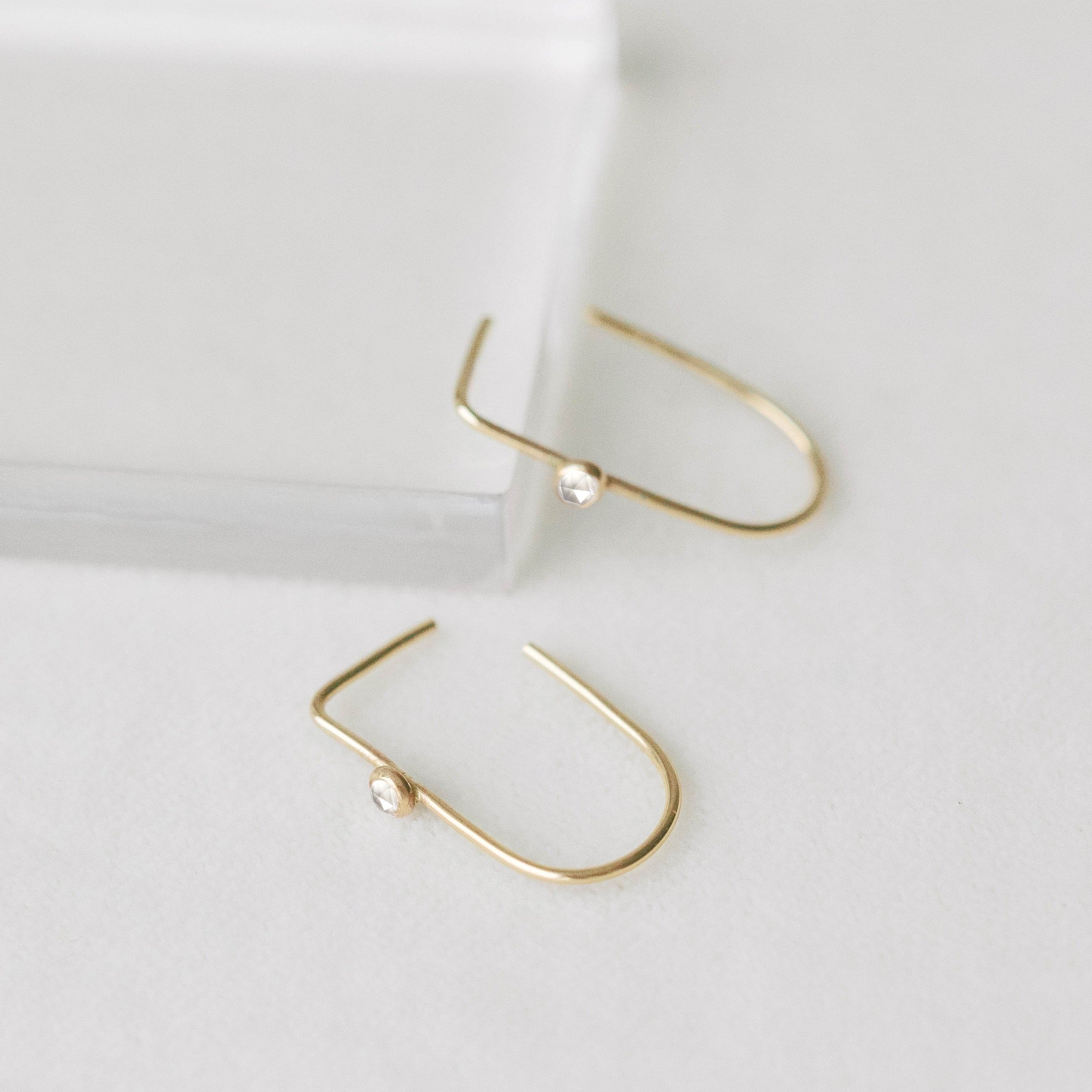 Big gold hoop earrings. Thin and light with genuine white topaz gemstones.