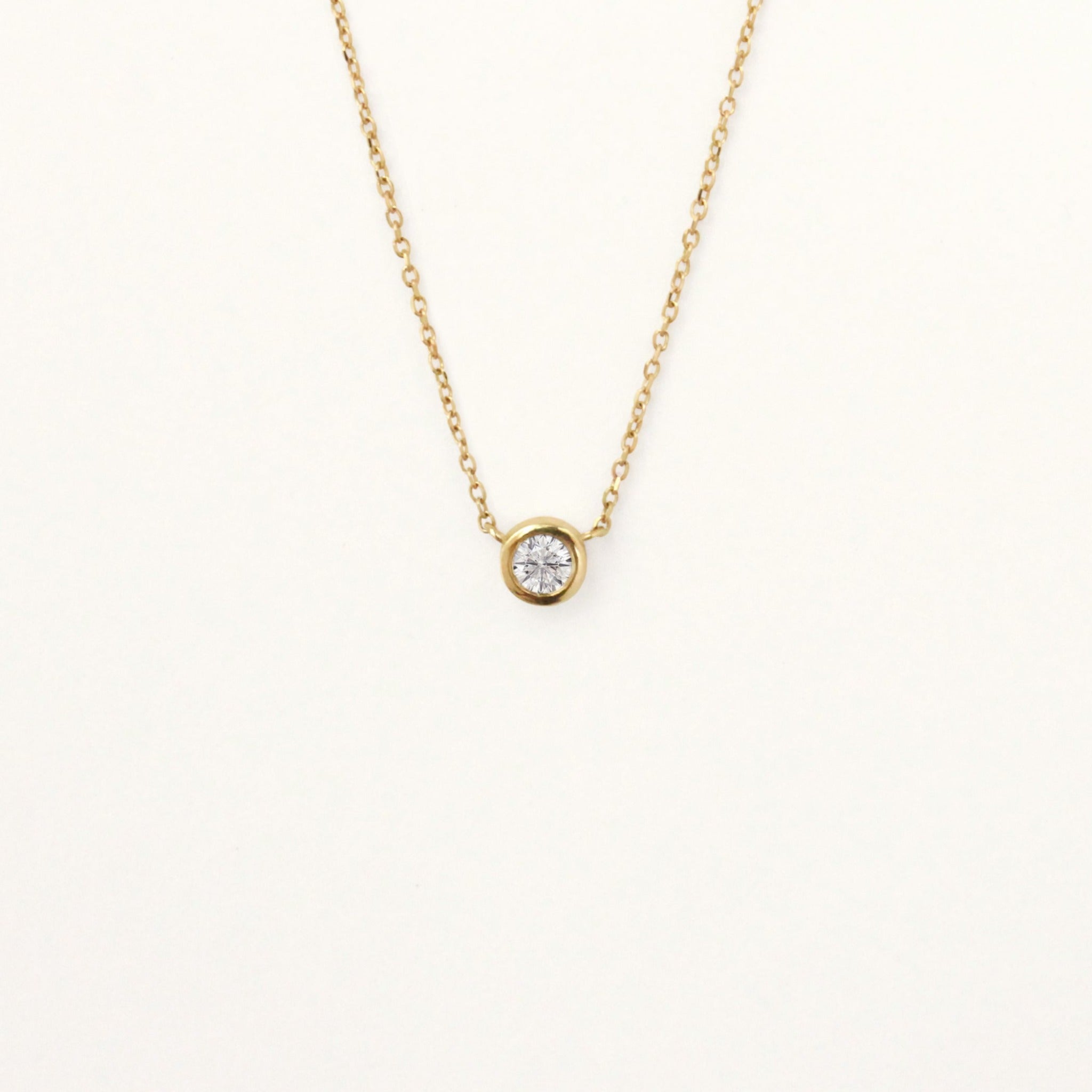 Brilliant cut diamond pendant necklace on a thin gold 14k yellow chain.
