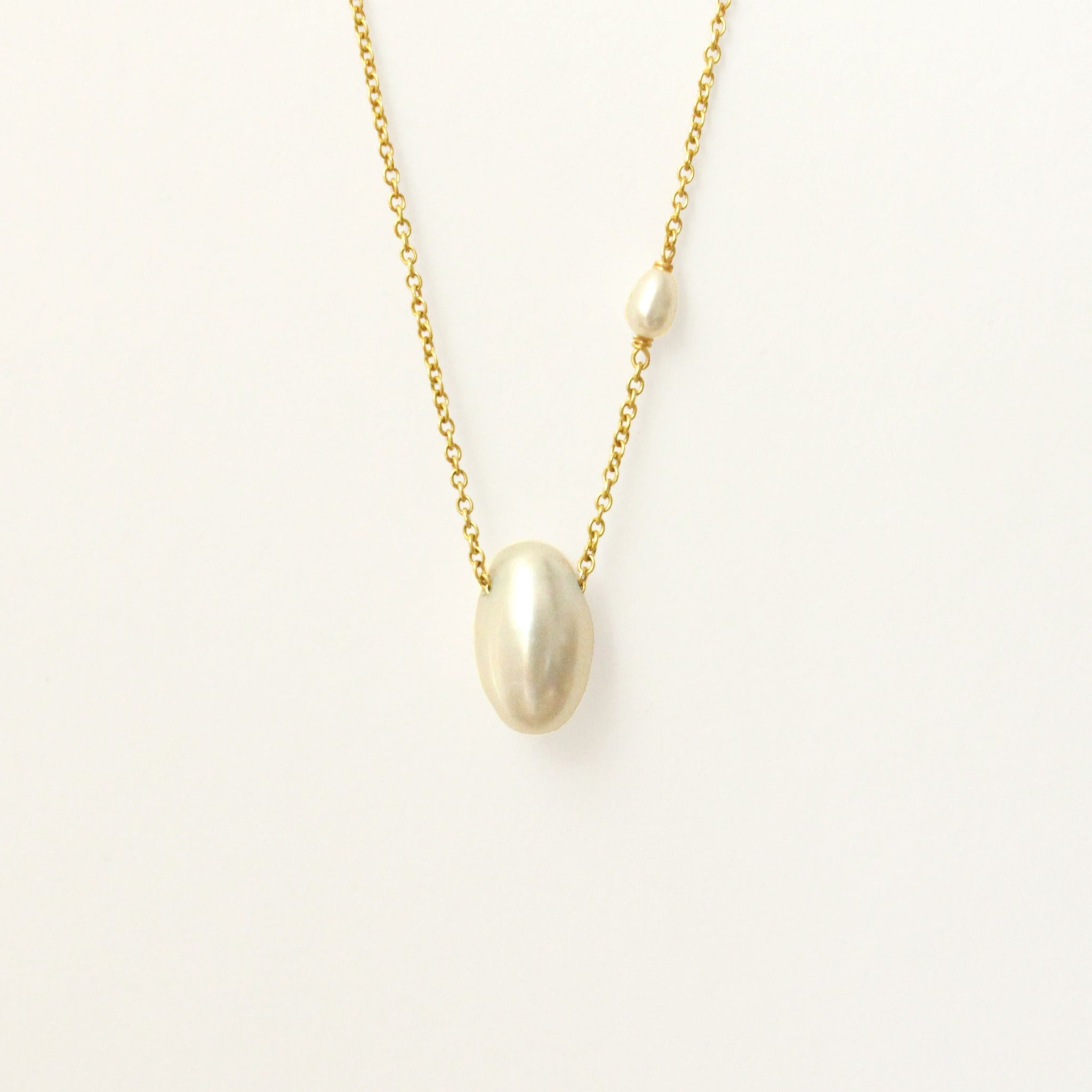 14k yellow gold necklace with one pearl drop and a small pearl accent