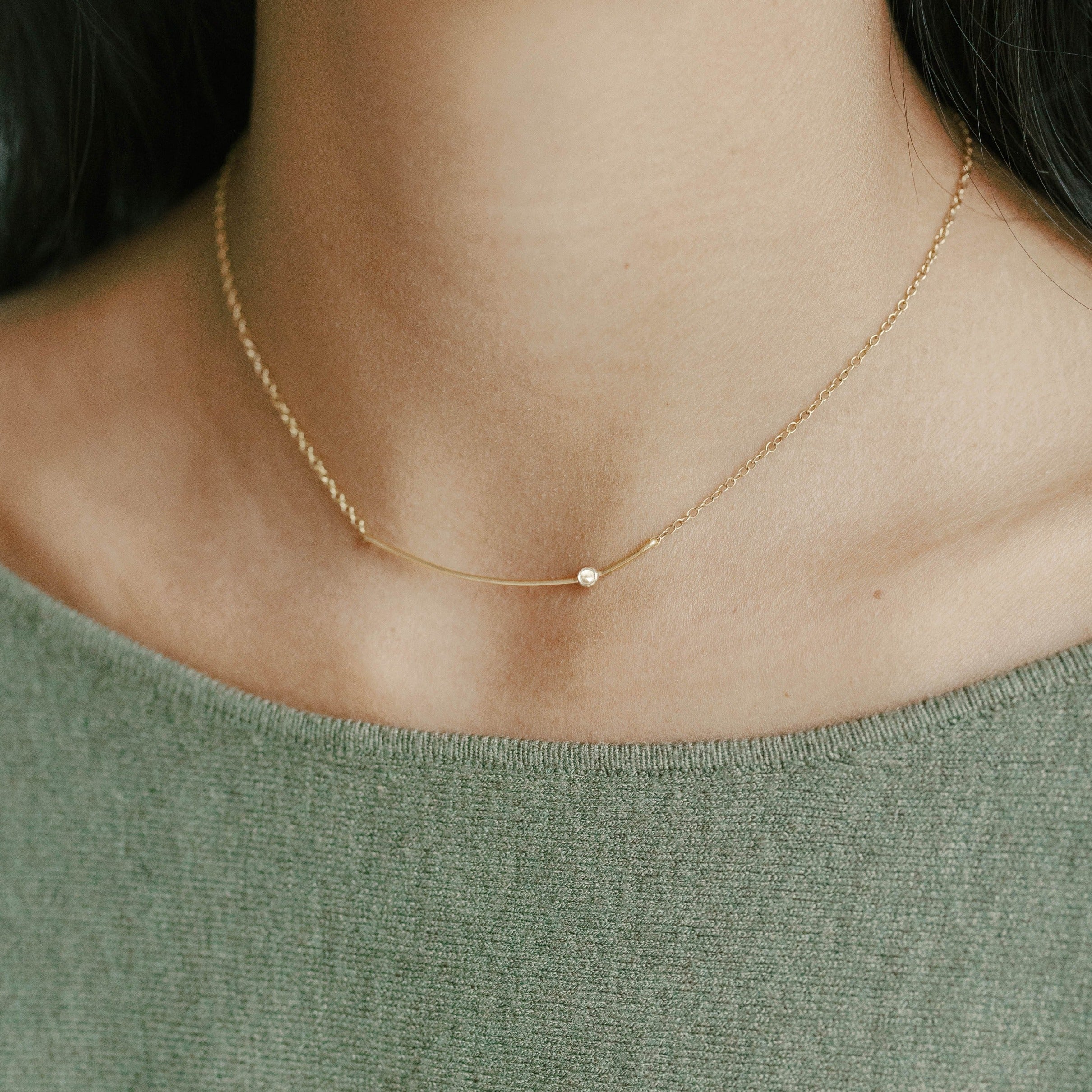 Recycled gold curved bar necklace with white topaz