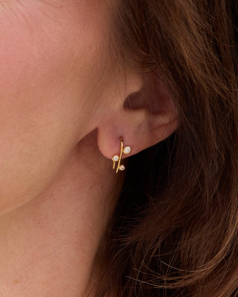 Gold hook style earring with floating white gemstones