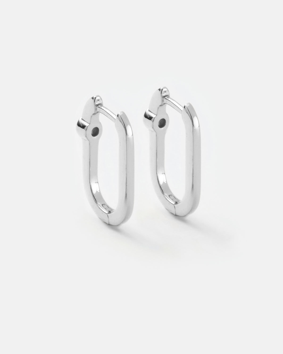 Midi reversible sterling silver hoop earrings showing the smooth polished silver side