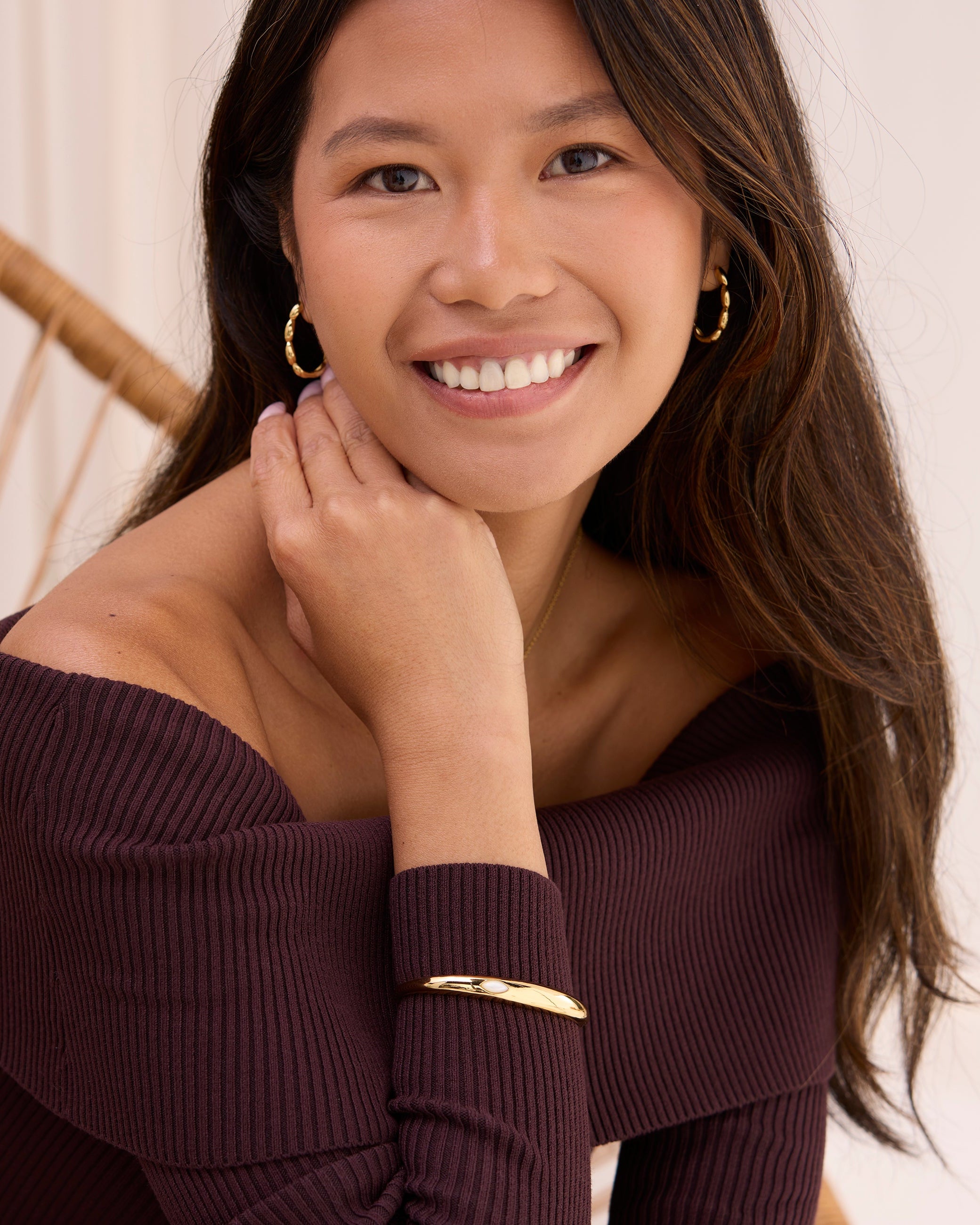 Women wearing large beaded hinge hoops. Reversible hoop earrings.