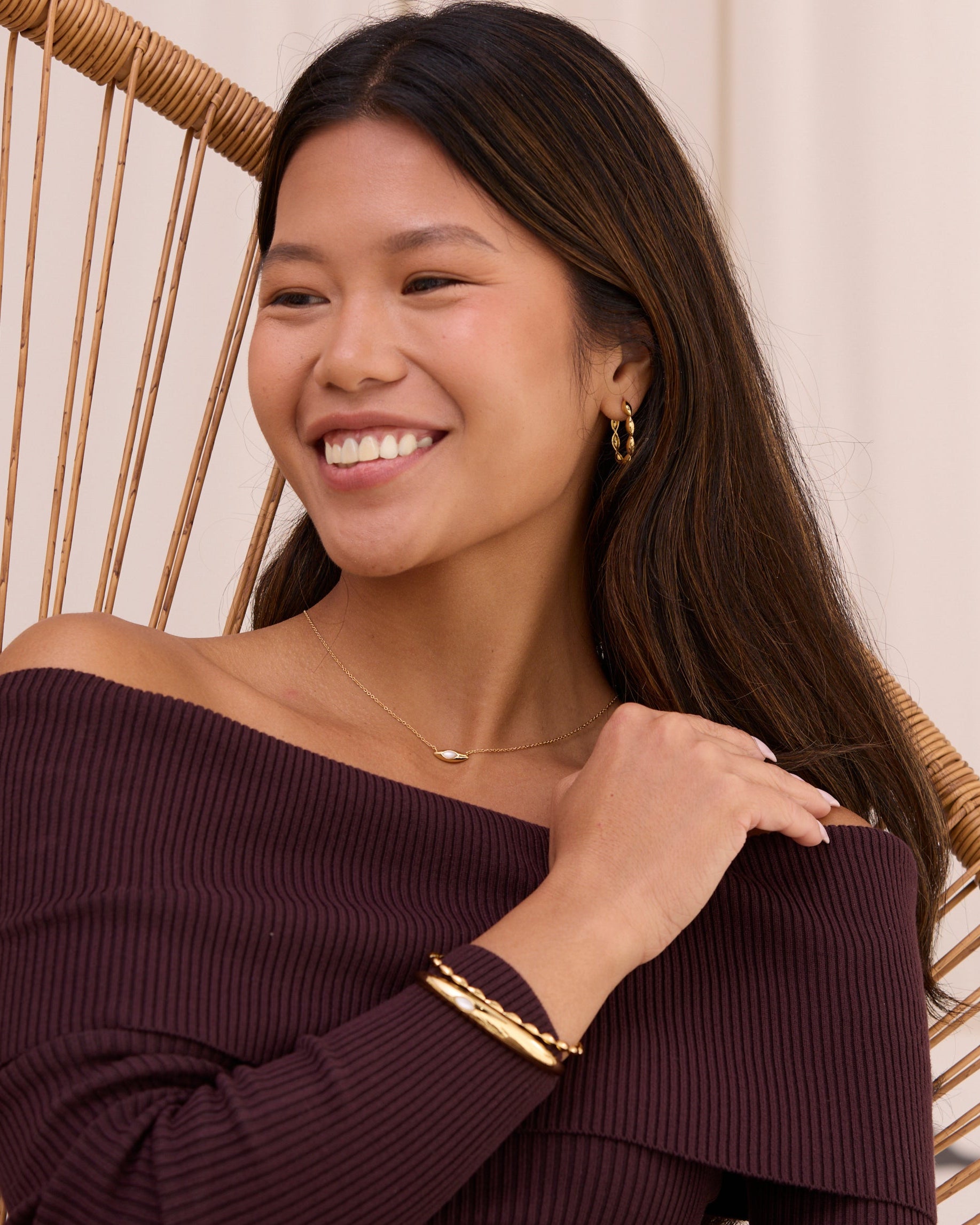 Large gold hoop earrings lightweight with petal shaped necklace.