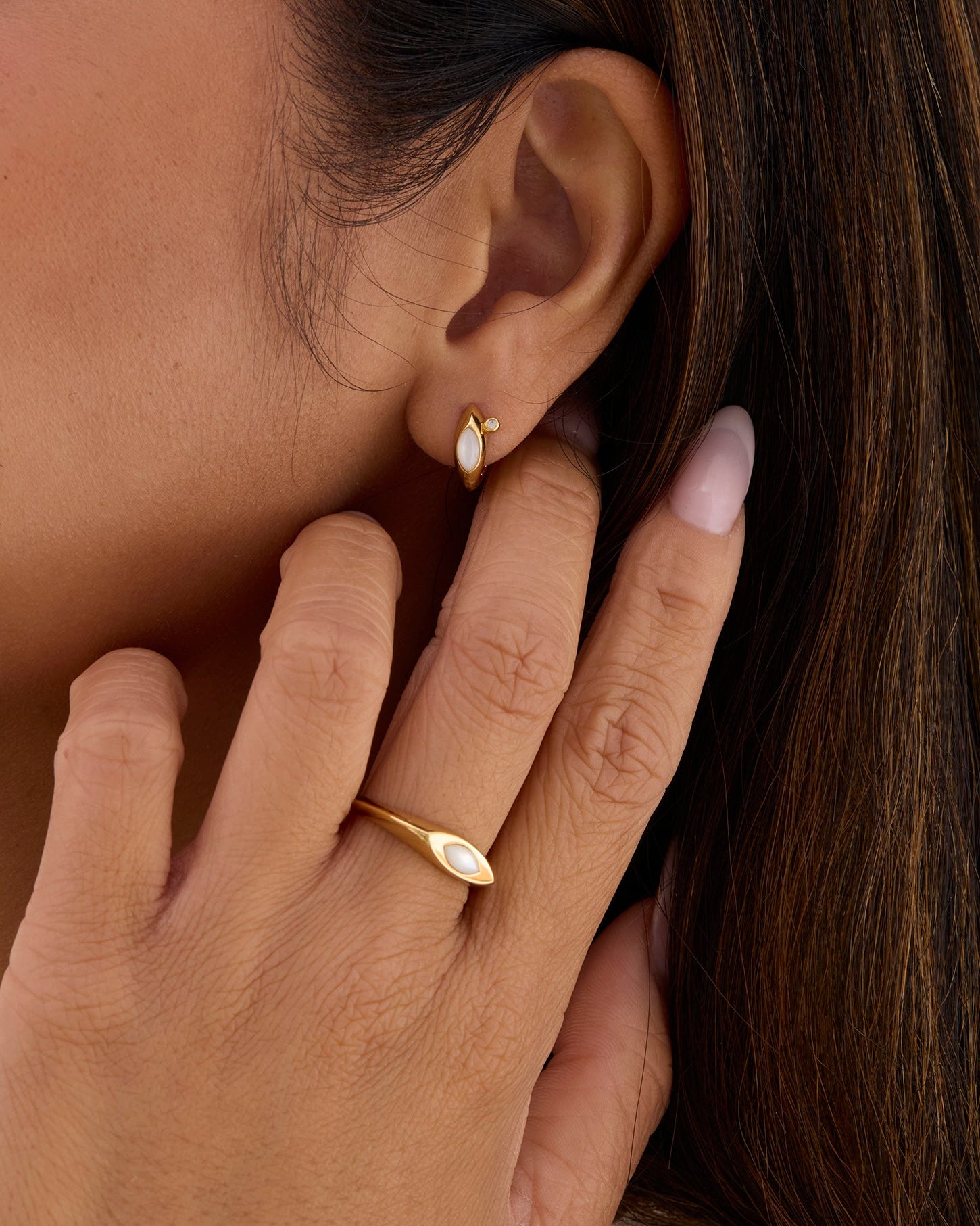Gold signet ring that is feminine with a white pearl.