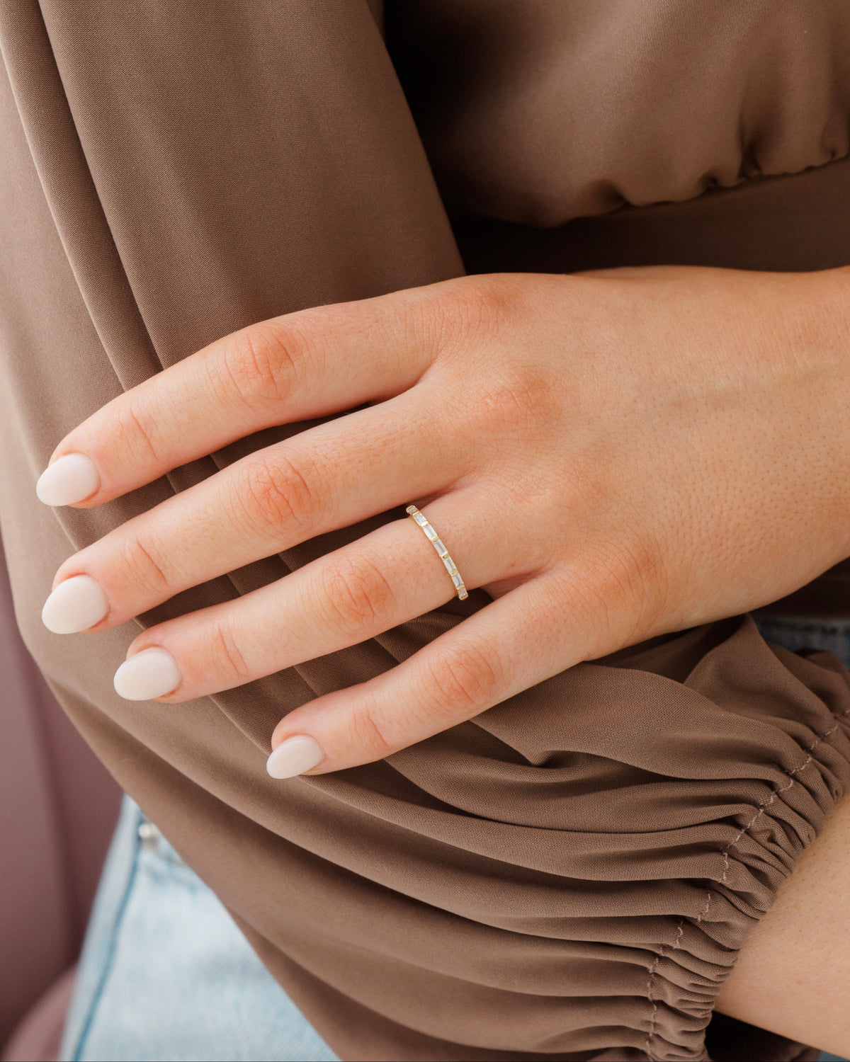 Baguette eternity ring on a women's ring finger.