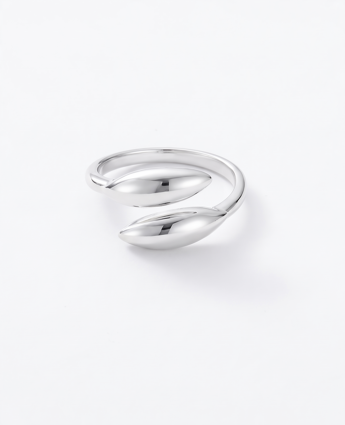 A polished silver wrap ring with a smooth, organic leaf-like design, photographed on a clean white background.
