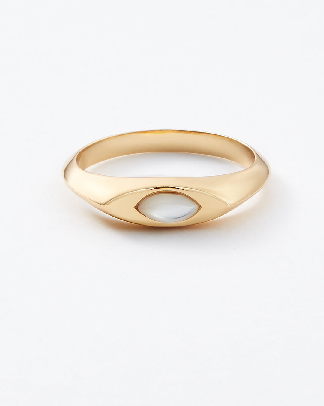 A polished gold signet ring with a smooth, rounded bezel-set oval white stone, photographed on a clean white background.