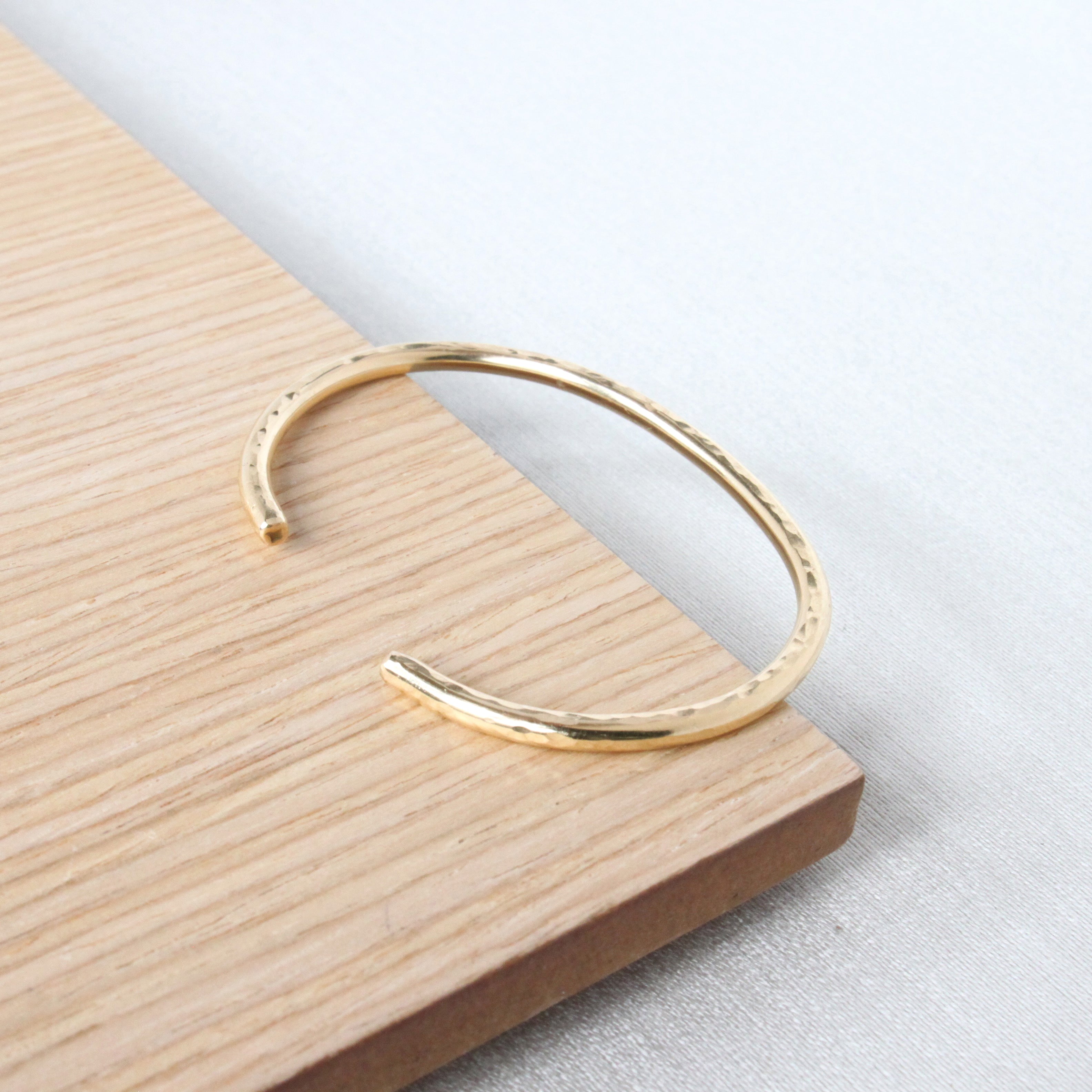 gold cuff bracelet ready to wear everyday. This gold cuff is made with recycled gold and is adjustable. The hand hammered finish is made by hand.