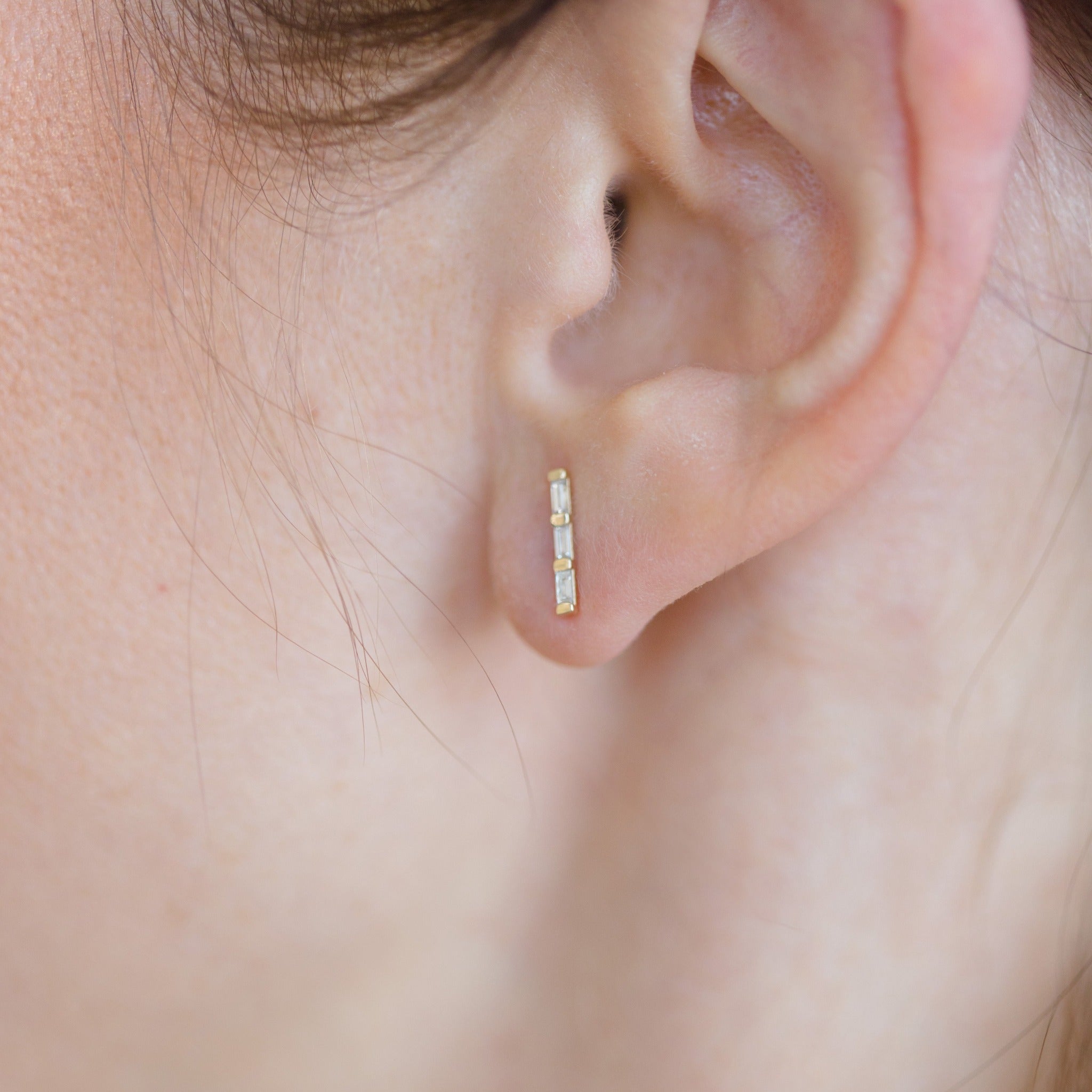Triple Baguette diamonds per earring. Each diamond gemstone is rectangular and brilliant.