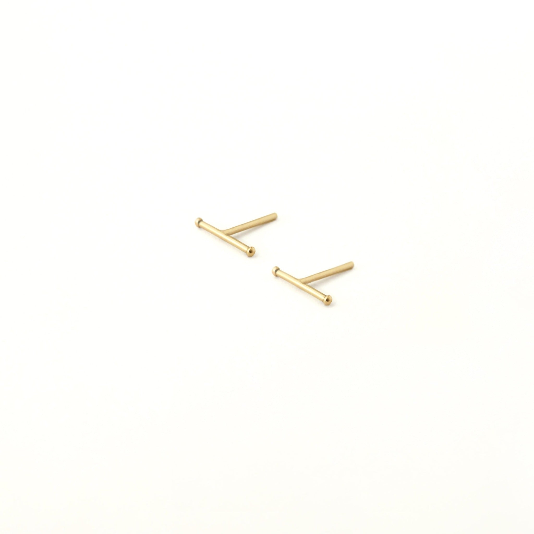 Barely there gold bar earrings. The ends have little round gold balls.