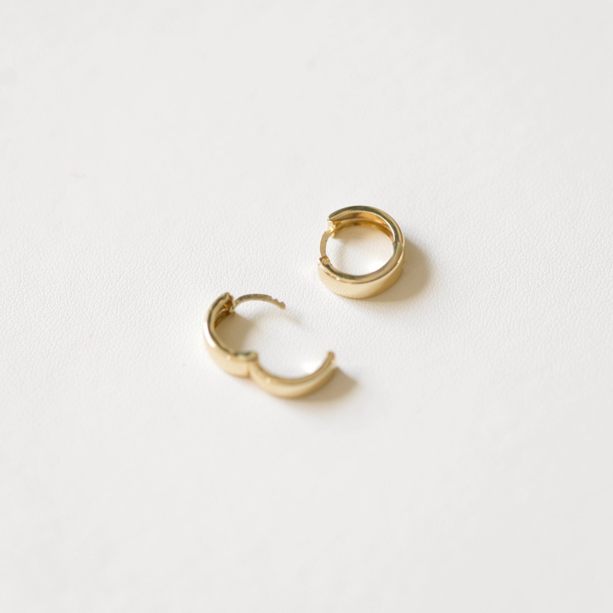 These gold hoop earrings click on and off your ear easily. Simple and elegant hoops look solid and heavy, but are hollow.