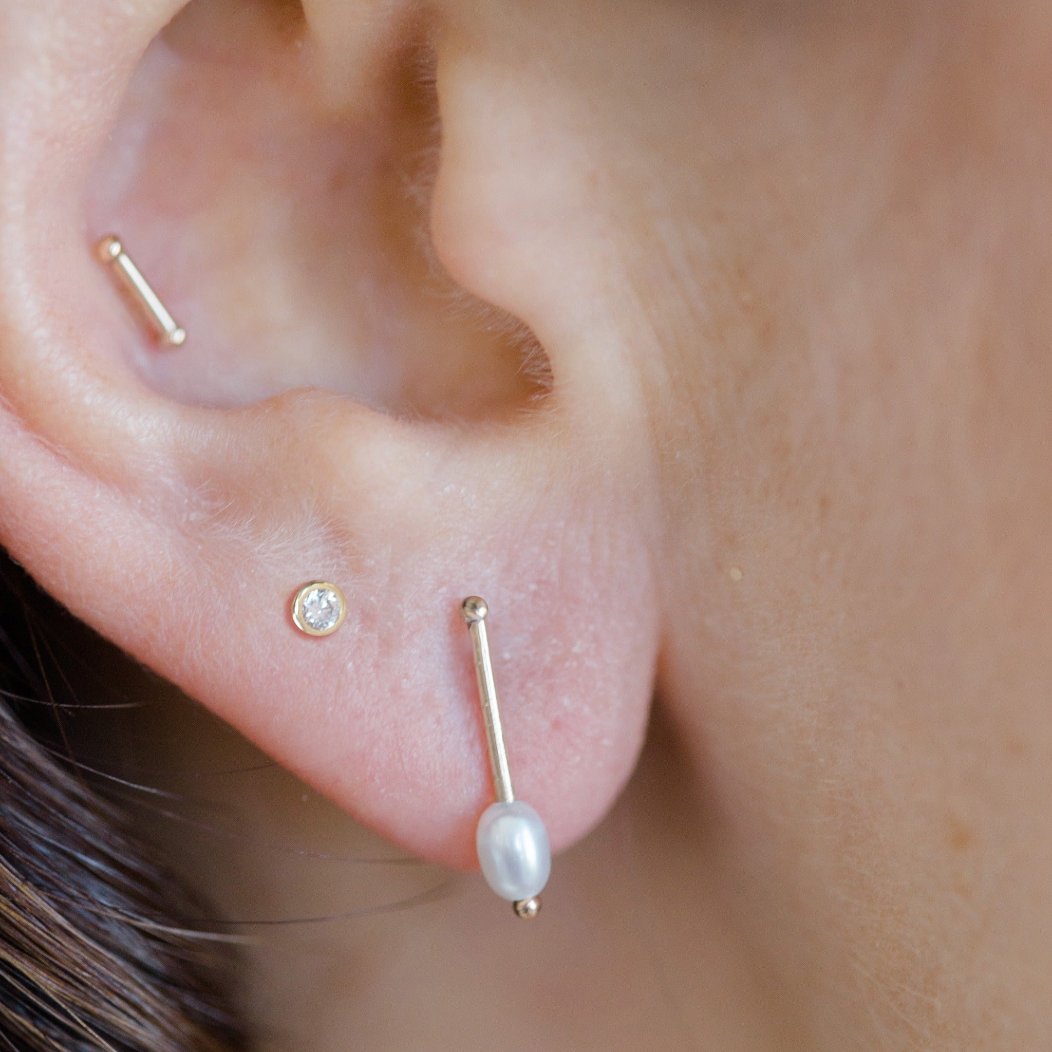 Combine this stud earring with other solid gold favorites for a well curated stylish ear.