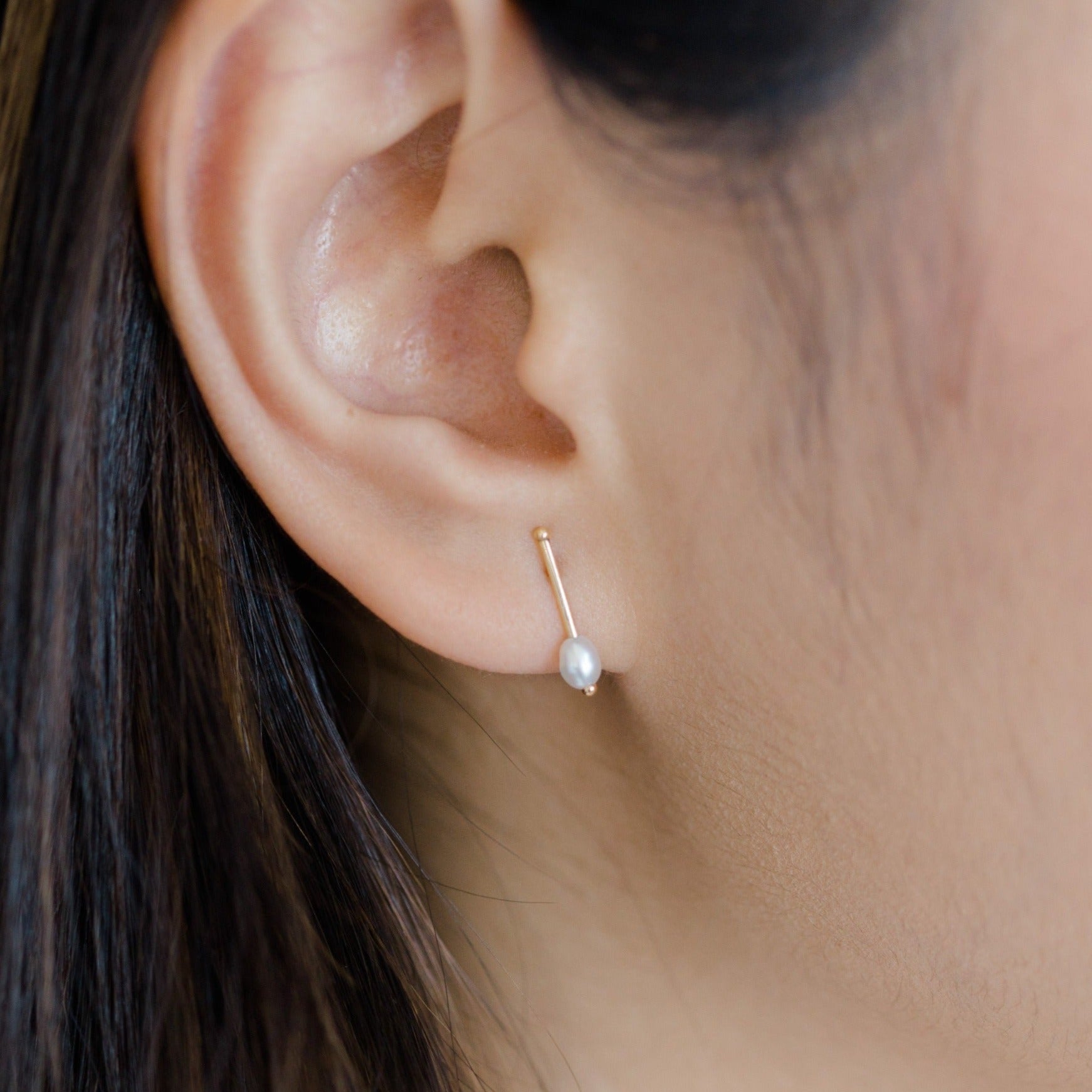 Delicate gold bar earring with a tiny white pearl. Handcrafted earring made with recycled 14k gold and natural pearl gemstone. Light and great for everyday wear.