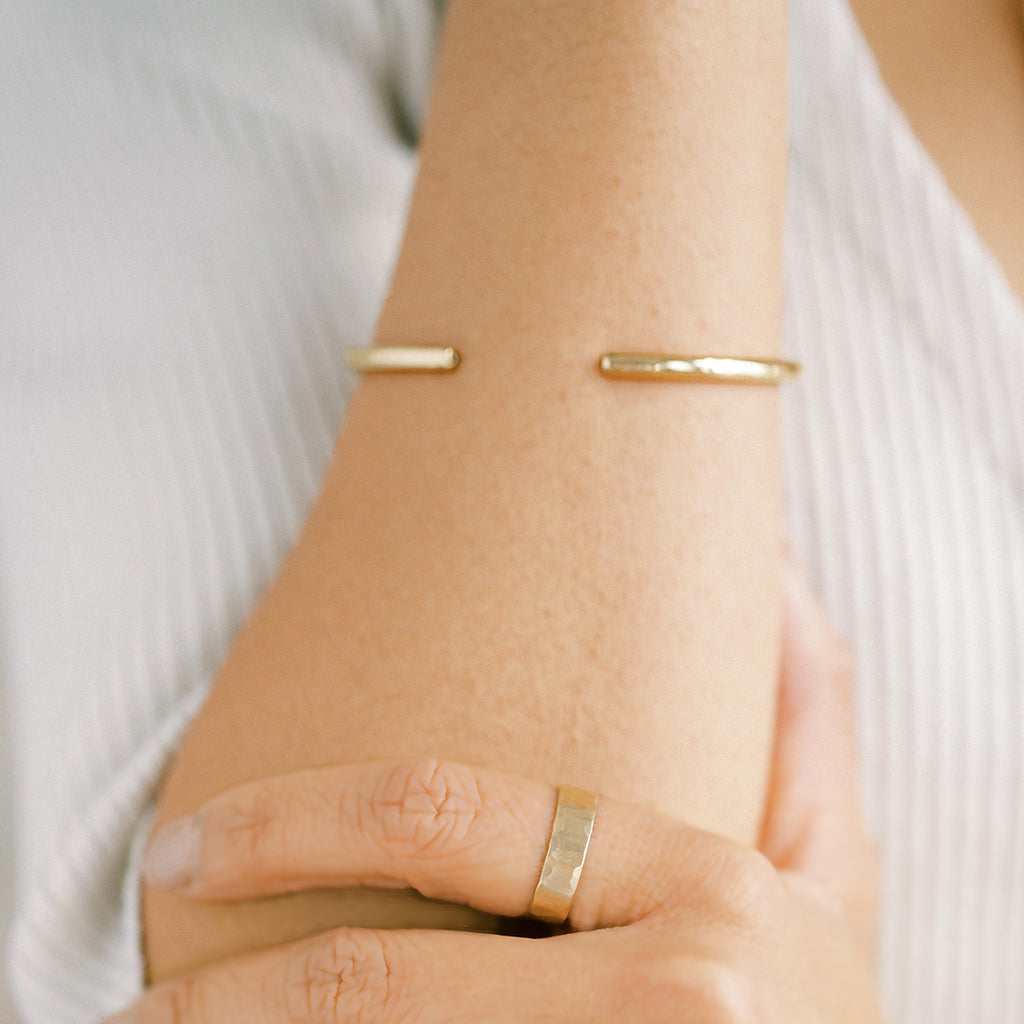 Beautiful simple gold cuff bracelet. This cuff bracelet is made by hand. It is adjustable and comes in a small and large size.