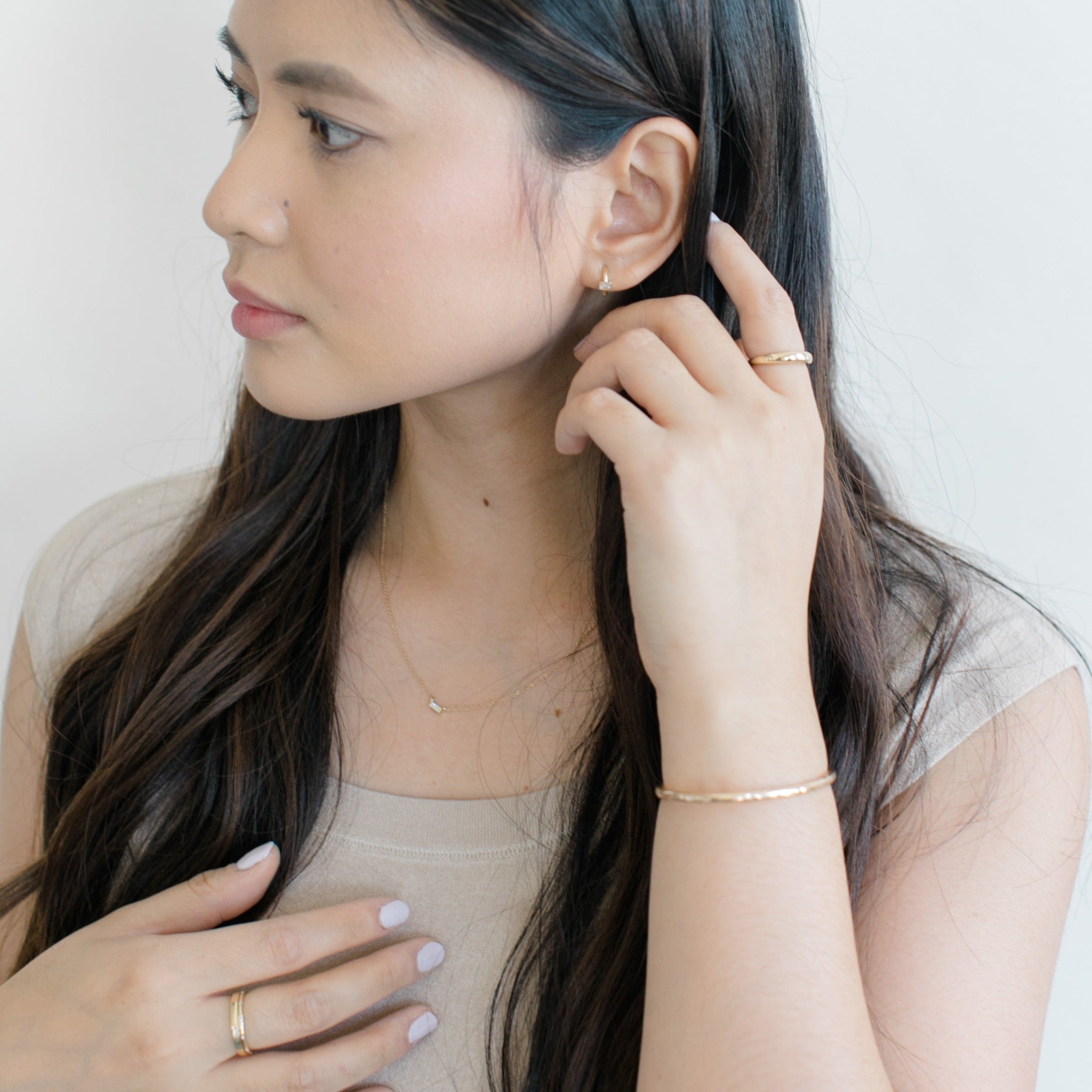 This thin delicate necklace looks great with gold huggie hoops, gold cuff and huggies shown here.