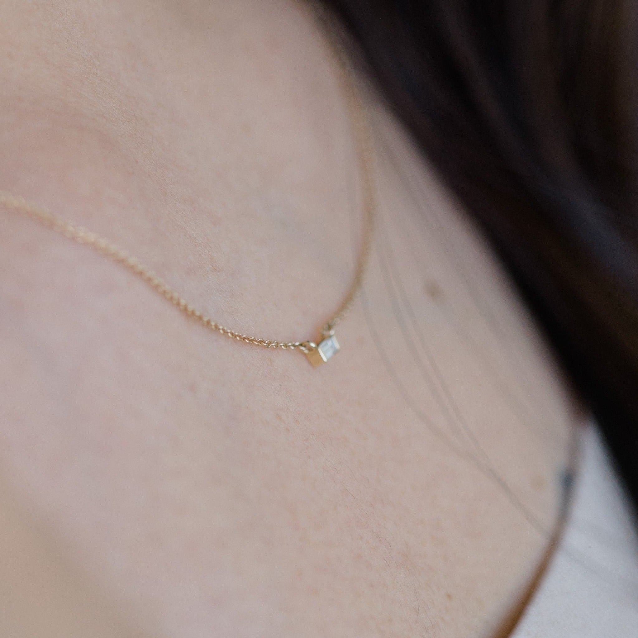 Dainty necklace is 14k yellow gold with a stunning rectangular diamond pendant.