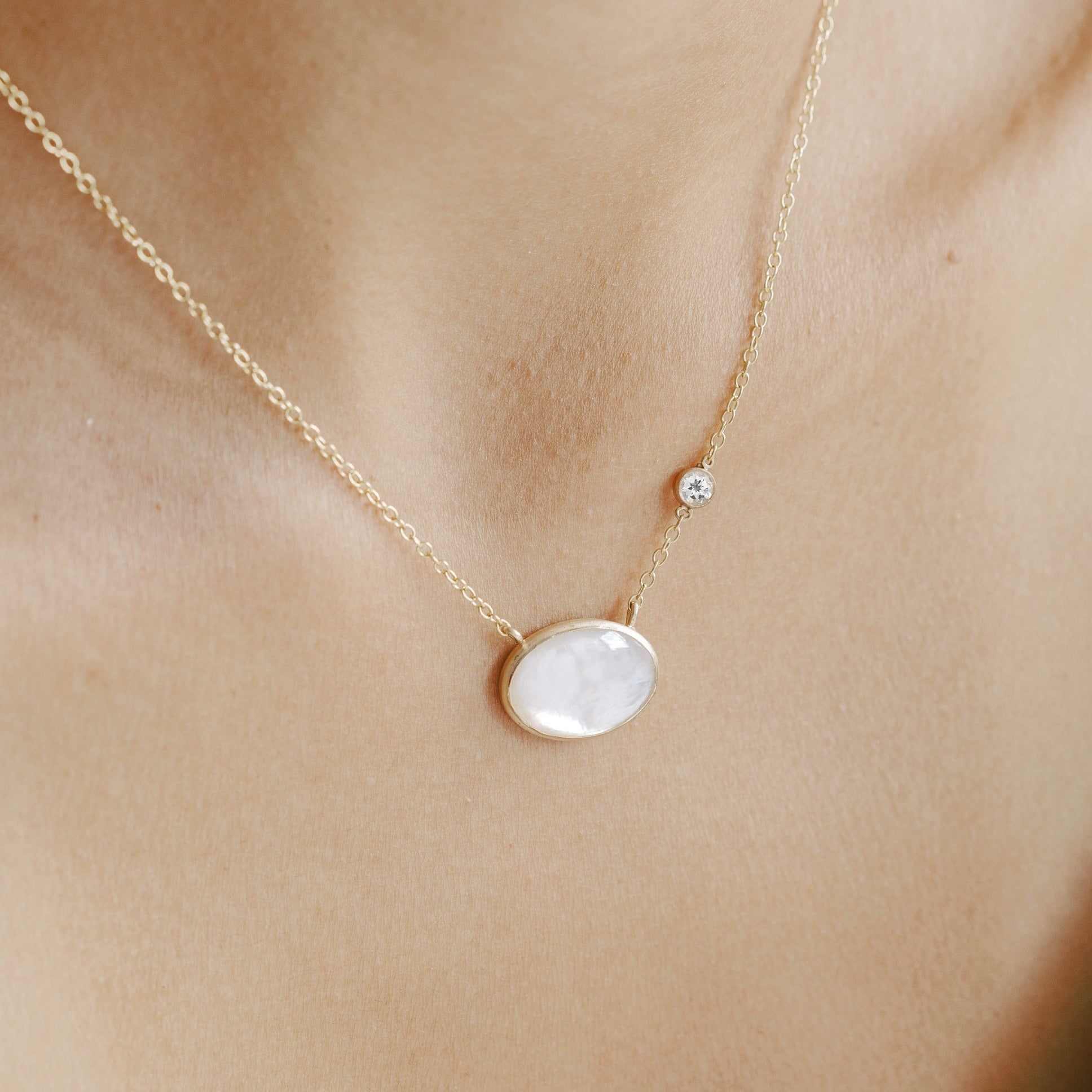Mother of pearl oval pendant and white topaz stone