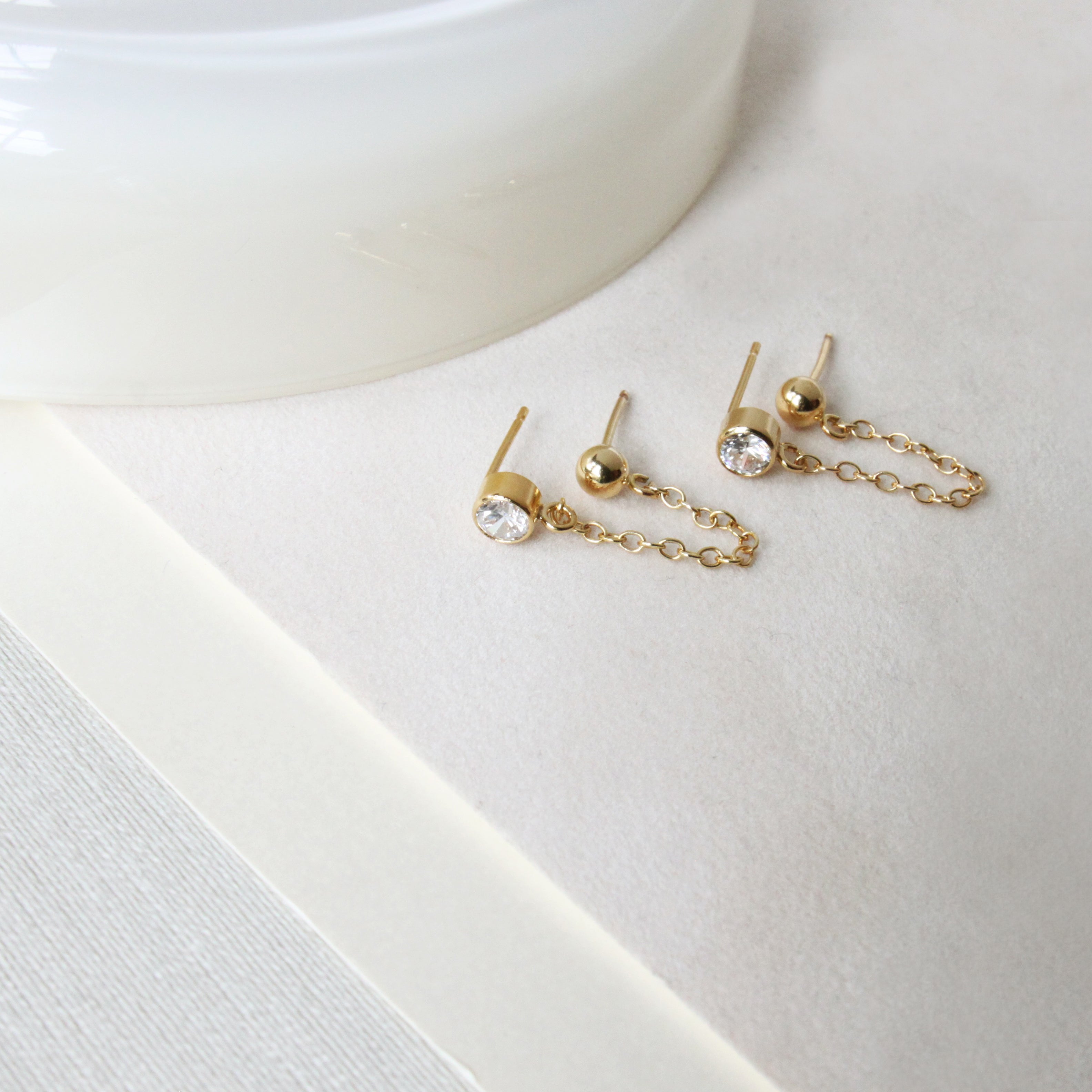 Gold earrings with a genuine white topaz stone